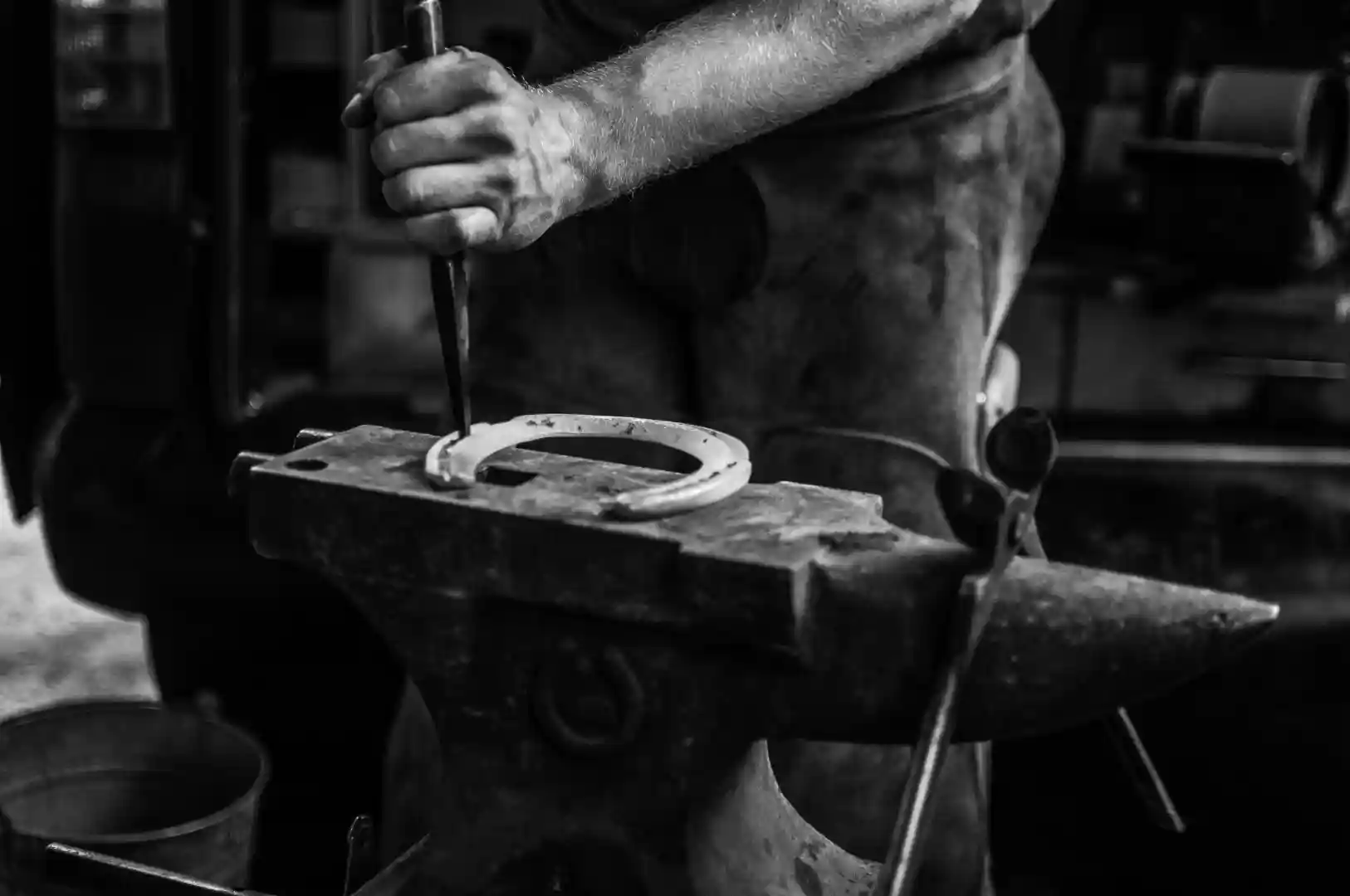 close up blacksmith forging horseshoe