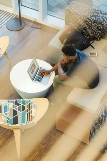 man working on a laptop in an open office